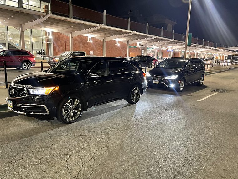 A couple of cars parked in front of a building