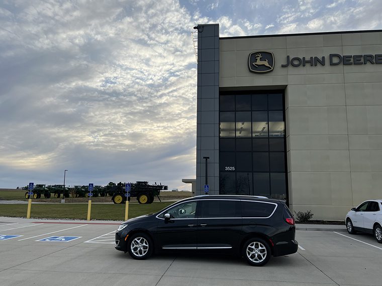 A black van parked in front of a building