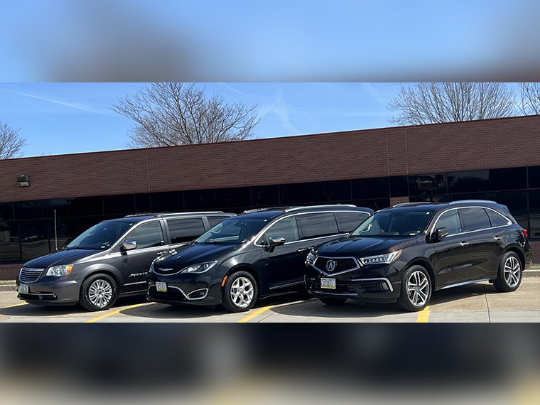 A row of cars parked in a parking lot